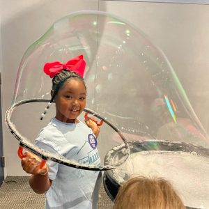 A young girl plays with a large bubble exhibit at McWane Science Center in downtown Birmingham.