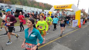 Runners leave the yellow blow-up starting gate to begin the 48th annual Sam Lapidus Montclair Run