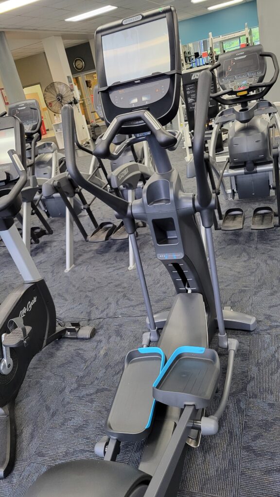 An elliptical machine among many other pieces of equipment on a fitness floor