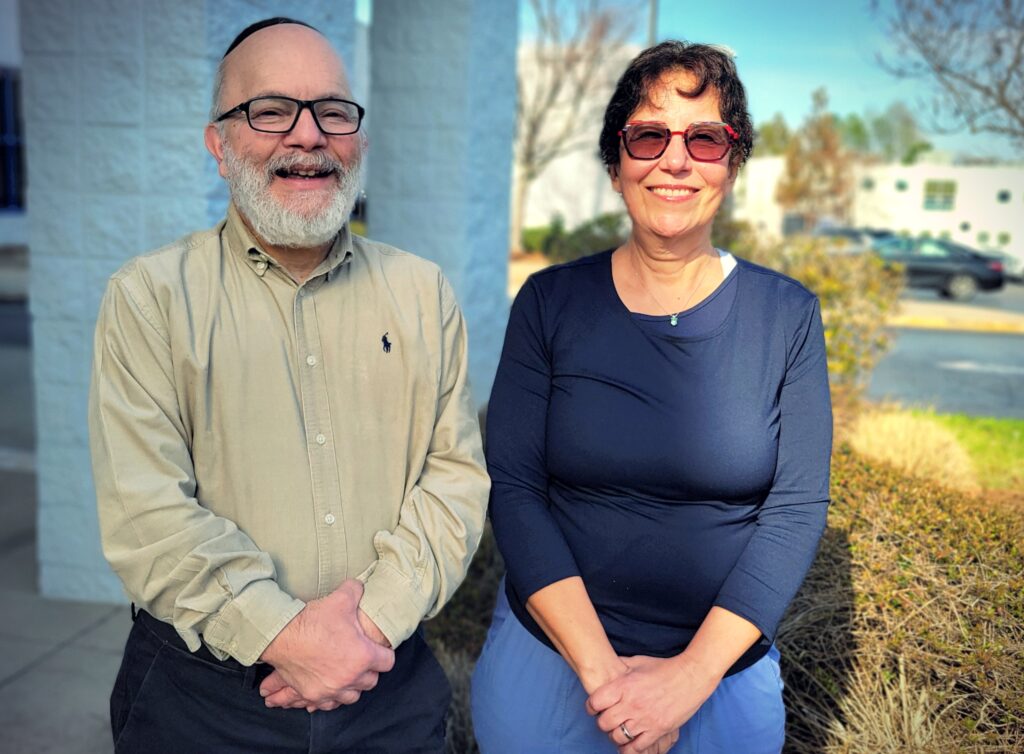 A man and a woman stand next to each other outside the Levite Jewish Community Center