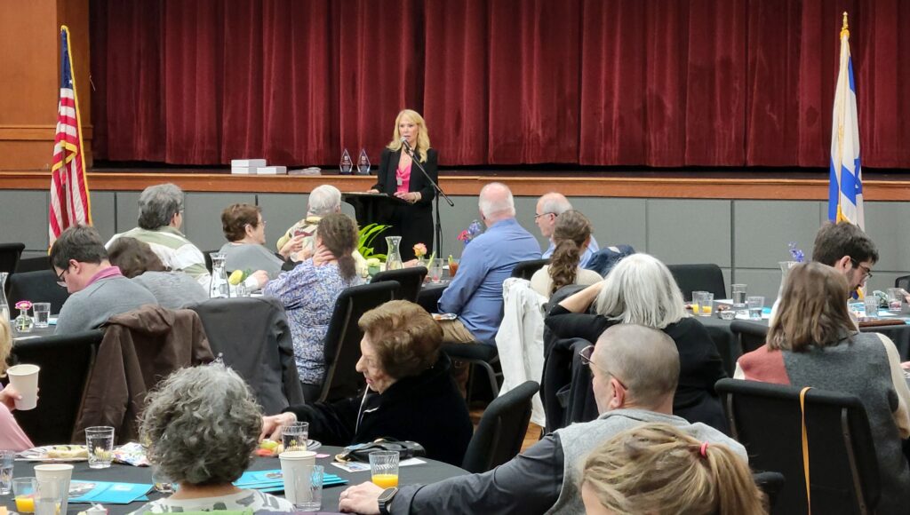 A woman speaks at a podium during the LJCC annual meeting