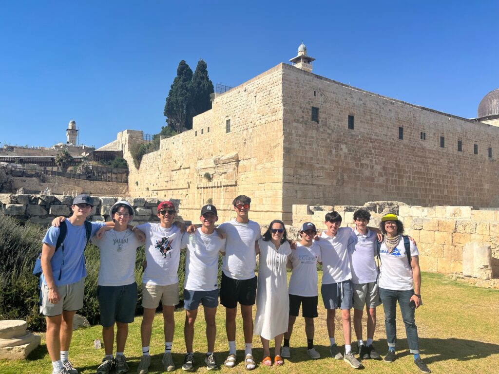 A group of people line up outside near a corner of Jerusalem's Old City