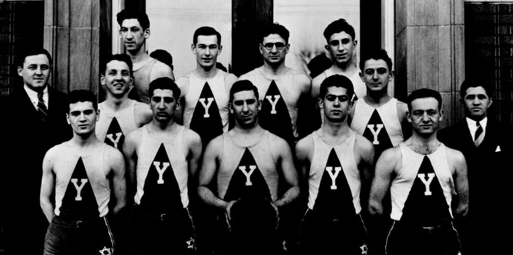 A black and white photo from the 1930s showing 10 adult male basketball players and two coaches