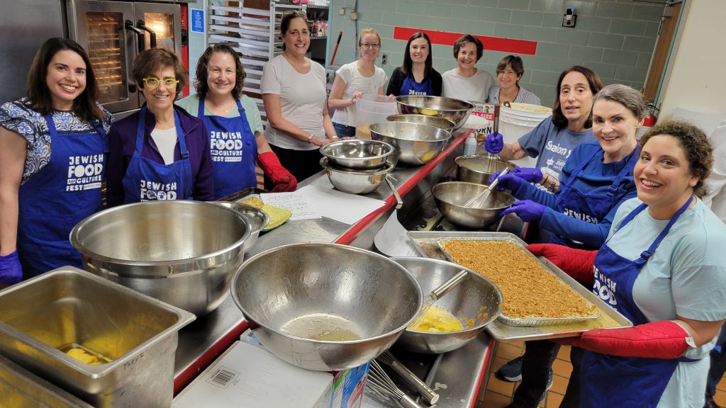 Volunteers prepare pans of kugel, a sweet noodle dish, in The J's kosher kitchen in preparation for the 2025 Jewish Food and Culture Fest